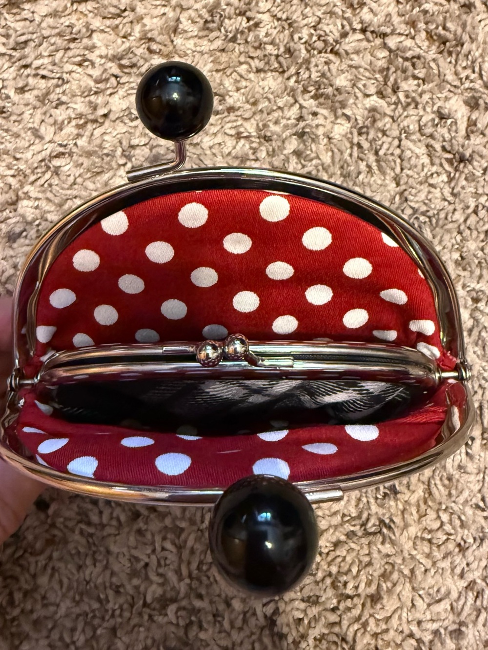 Coin purse with red and white polka dot interior.
